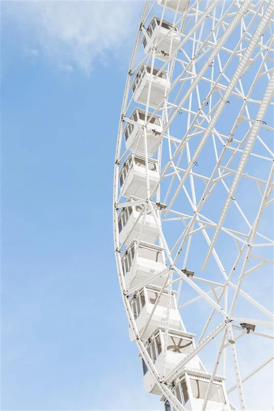 Ferris wheel with a blue sky in the background.