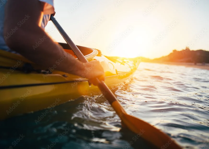 Close-up of kayaking on calm water at sunset near Rother Valley holiday rentals.