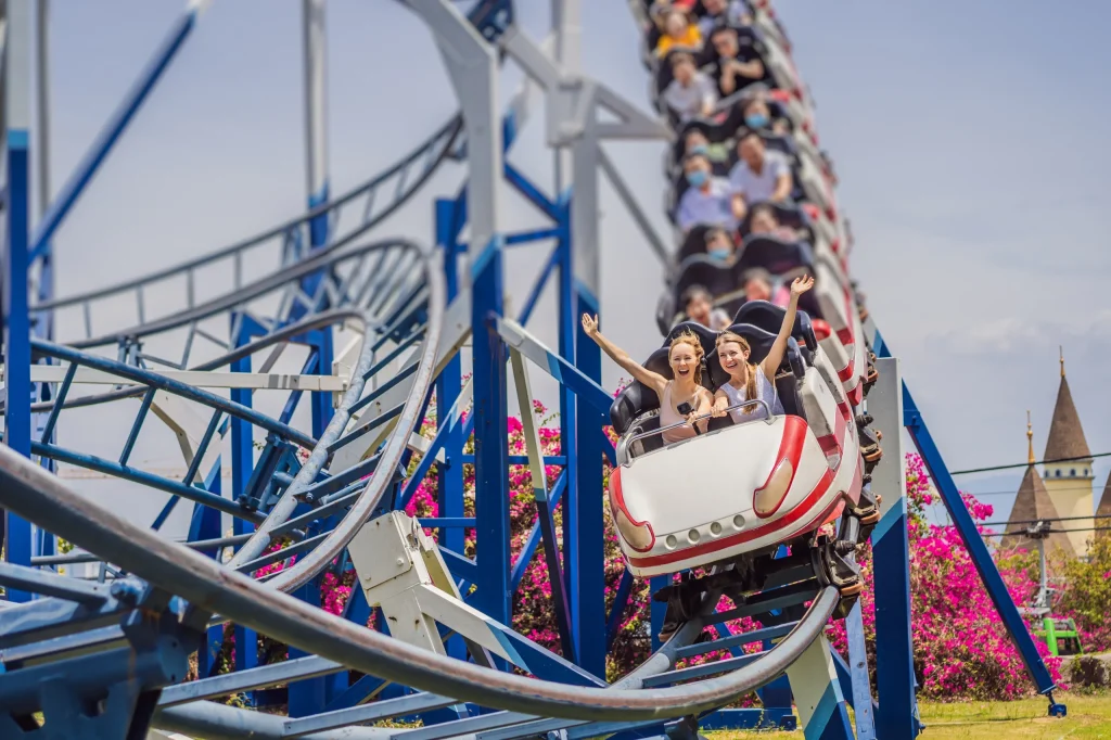 Excited visitors enjoying a thrilling roller coaster ride at Gulliver’s Valley Rother Valley theme park on a sunny day.