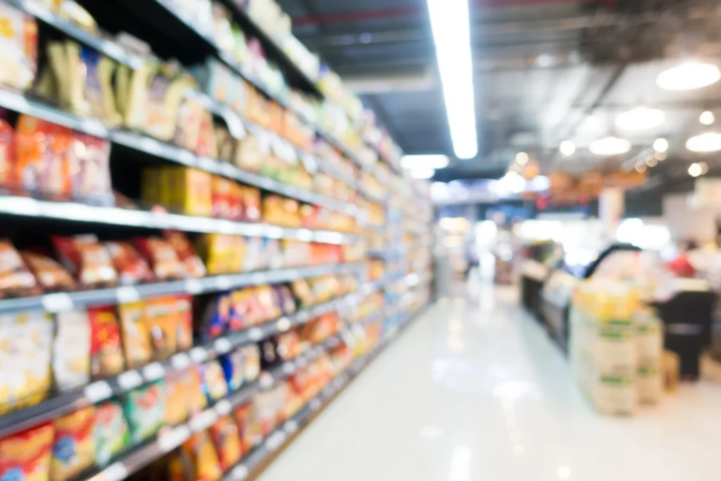 Blurred view of supermarket aisles stocked with products, representing local shopping experiences during family days out Rother Valley.